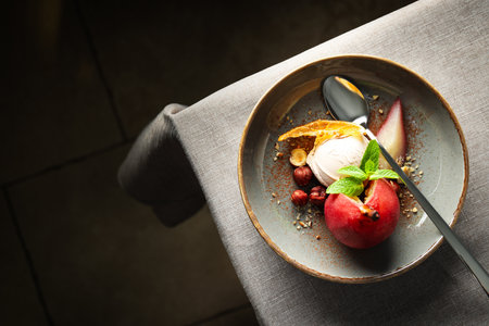 Ice cream and pear on plate and spoon on light background, space for textの写真素材