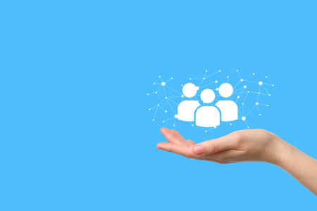 A hand holds user icons, symbolizing digital connection and social interactionの写真素材