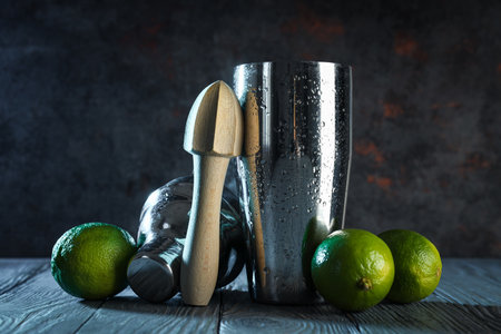 Metal shaker with fresh lime on a dark backgroundの写真素材