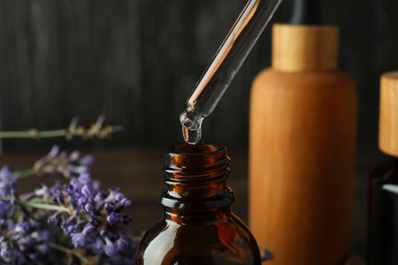 Lavender oil in a bottle with a dropper close-upの写真素材