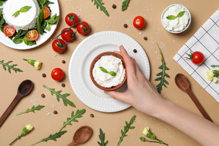 Ricotta in a bowl with fresh tomatoes and herbsの写真素材