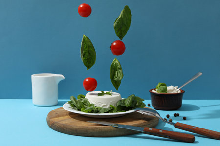 Ricotta in a bowl with fresh tomatoes and herbsの写真素材