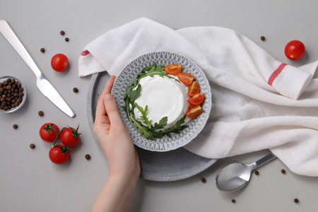 Ricotta in a bowl with fresh tomatoes and herbsの写真素材