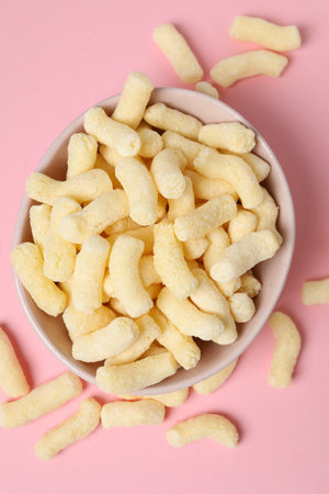 Many corn sticks in bowl on pink background, top viewの写真素材