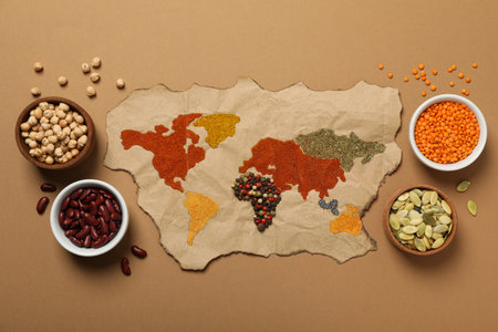 Map, spices, seeds and beans on beige background, top viewの写真素材