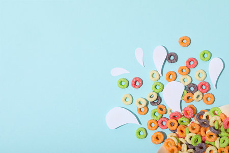 Colorful cornflakes, concept of tasty breakfast, morning food, space for textの写真素材