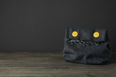 Handmade denim bag on table on gray background, space for textの写真素材