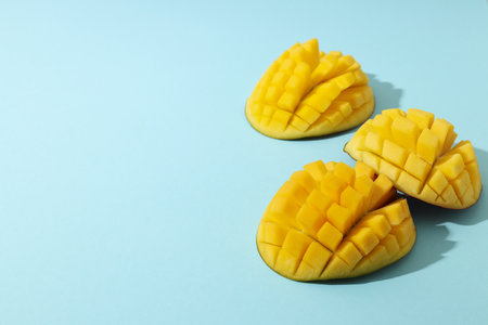 Ripe sliced mango on a blue backgroundの写真素材