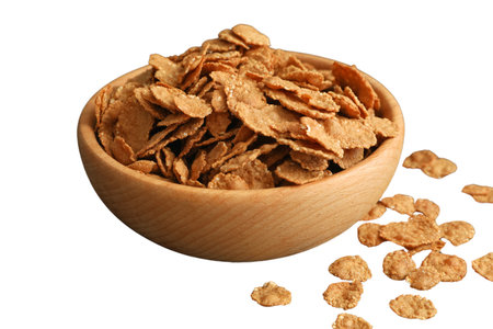Close-up of crispy cereal flakes in a bowl, isolated on white