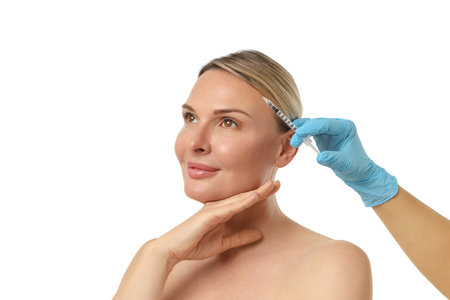 Woman getting facial enhancement shot, isolated on white, PNGの写真素材