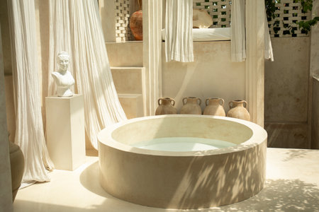 Bright and tranquil bathroom space showcasing a circular bathtubの写真素材