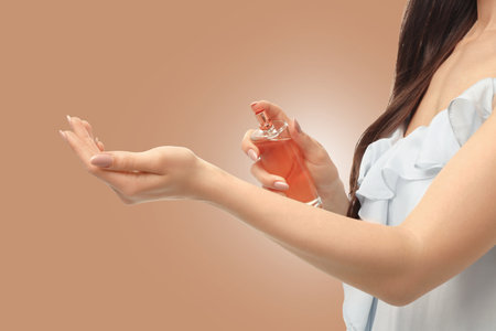 A woman gently applies fragrance on her wrist with elegant gesturesの写真素材