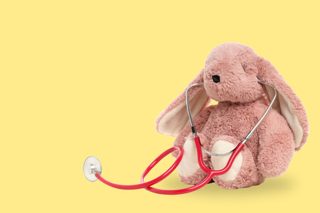 Bunny with stethoscope on a bright yellow backgroundの写真素材