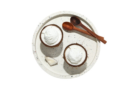 Coconut dessert in bowls with wooden spoons, isolated on white, PNG