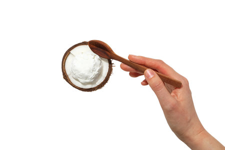 Hand with spoon over coconut ice cream, isolated on white, PNGの写真素材