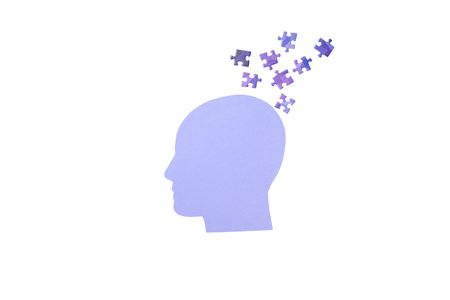 Puzzle pieces float above a purple head, isolated on white, PNGの写真素材