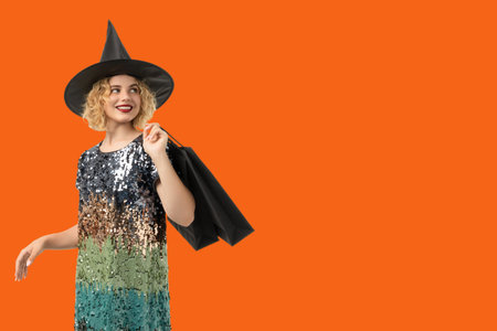 Young woman in witch costume joyfully carries shopping bags