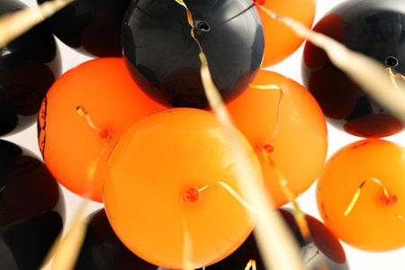 Orange and black balloons set a festive vibe, on white