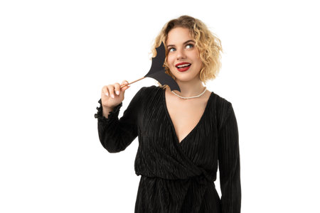 Playful woman with bat mask at Halloween, isolated on white, PNG