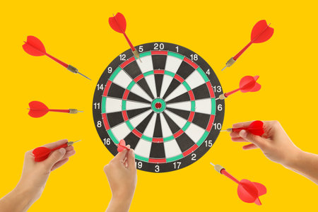 Darts are thrown with precision aiming at the dartboard