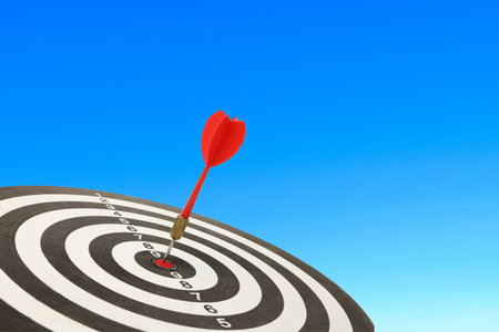 Dart strikes the center of a bullseye demonstrating precision