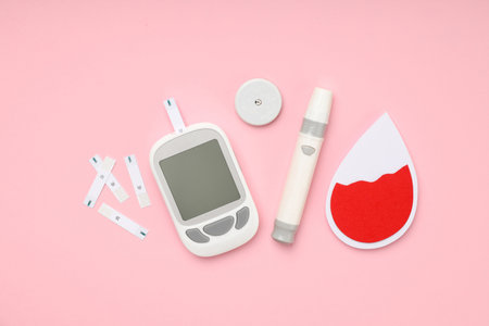 Various diabetes management tools on a pink backgroundの写真素材