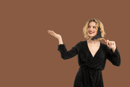 Woman in a stylish black outfit cheerfully enjoying Halloween funの写真素材