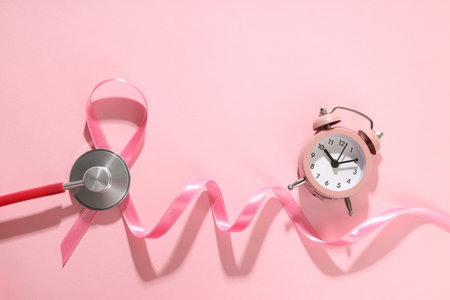 Stethoscope and clock on pink for breast cancer awarenessの写真素材