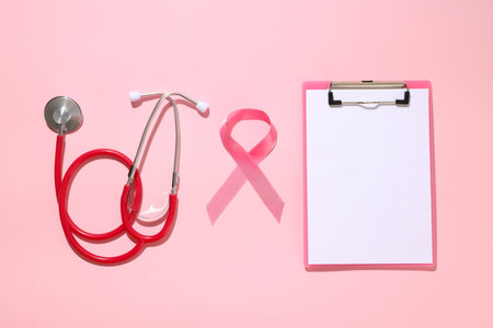 Medical stethoscope and pink ribbon on a light backgroundの写真素材