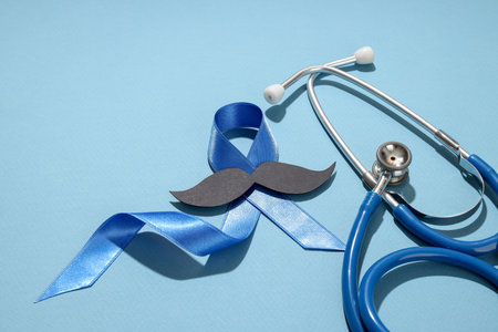 Blue ribbon, paper mustache, and stethoscope raise awareness.の写真素材