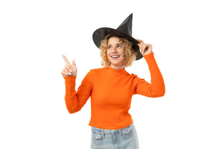 Young woman in orange sweater, witch hat, isolated on white, PNG