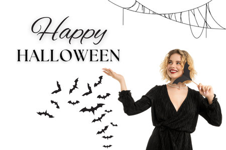 A woman joyfully welcomes Halloween with bats and decorationsの写真素材