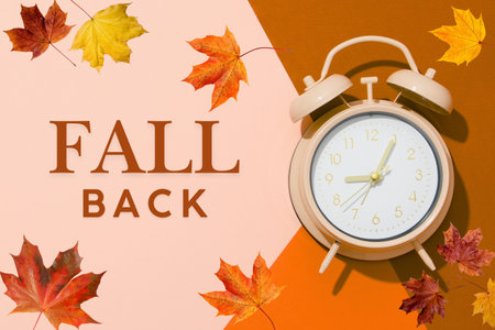Clock on a brown and pink background with autumn leavesの写真素材