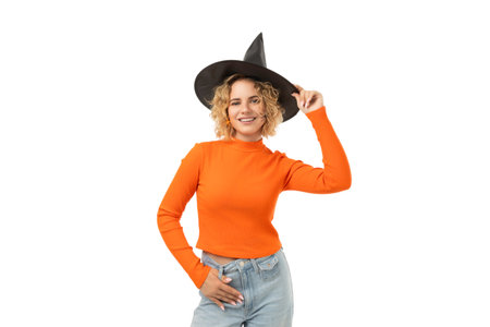 Young woman wears a witch hat and orange sweater, isolated, PNG