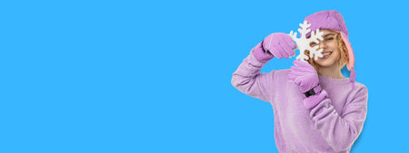 Girl in a purple sweater holds a snowflakeの写真素材