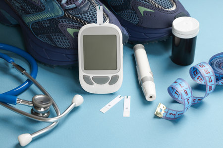 Diabetes kit, stethoscope, and shoes neatly arrangedの写真素材
