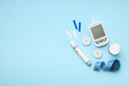 Glucometer and insulin pen on a blue backgroundの写真素材
