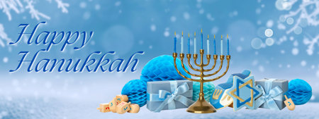 Menorah with blue candles surrounded by gifts and decorationsの写真素材