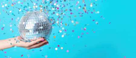 Disco ball held in hand surrounded by colorful confetti, created by AI