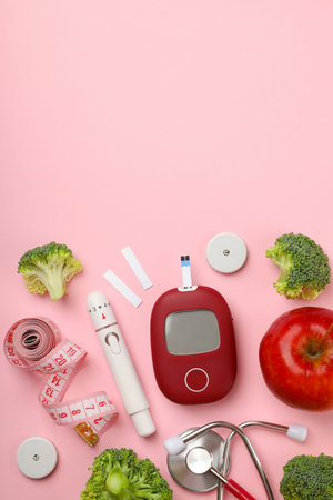 Tools for diabetes management and fresh foods displayedの写真素材