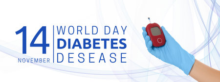 Blue-gloved hand with glucose meter for diabetes awarenessの写真素材