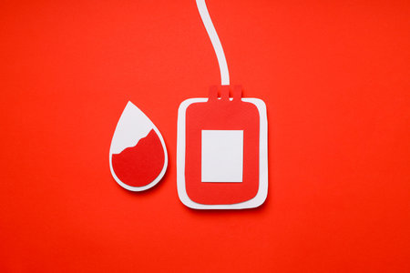 Blood bag and blood droplet on red backgroundの写真素材