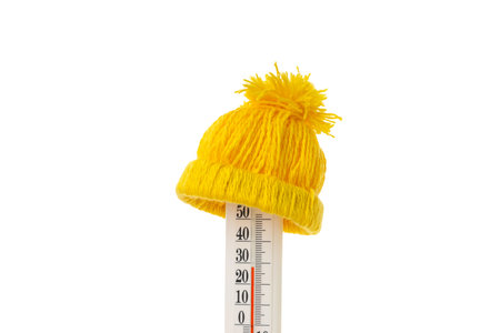 Yellow hat on a winter thermometer, isolated on white, PNG