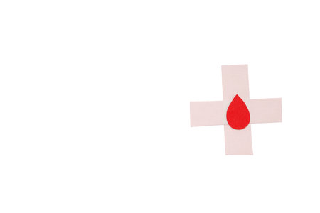 Red droplet on white cross representing blood donation, isolated, PNGの写真素材