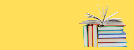Books are arranged on a yellow background with one open