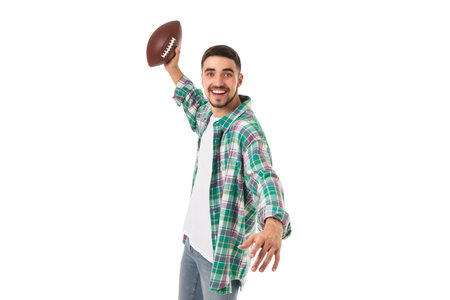 Excited man ready to throw a football, on white