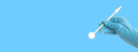 A person holds a dental tool ready for tooth careの写真素材