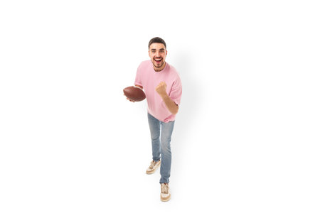 Player shows excitement while holding a football, isolated