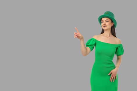 A woman in a green dress joyfully celebrates St. Patrick's Dayの写真素材