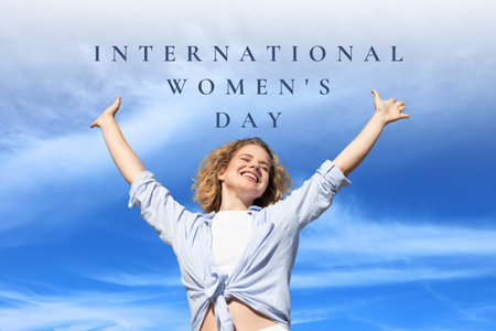 Woman celebrates International Women's Day with arms raisedの写真素材